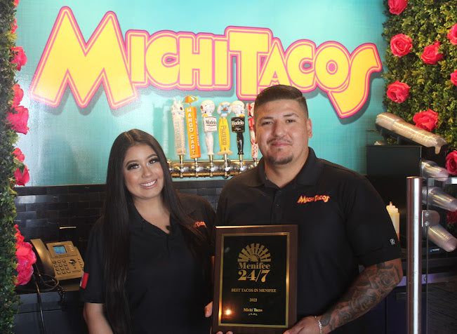 Michi Tacos co-owners Karol Serrano and German Herrera pose with their "Best Tacos in Menifee" plaque.